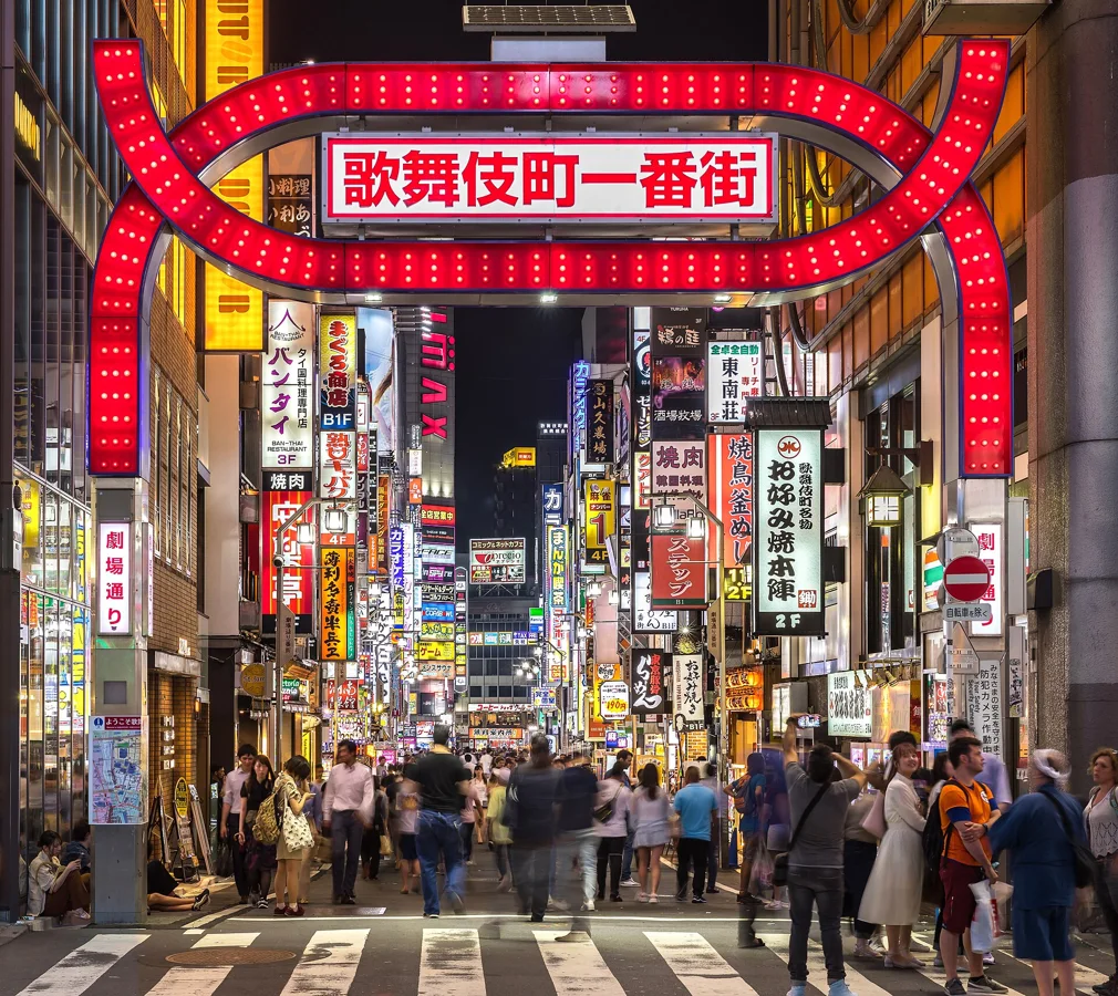Kabukicho red gate and colorful neon street signs at night, Shinjuku, Tokyo, Japan