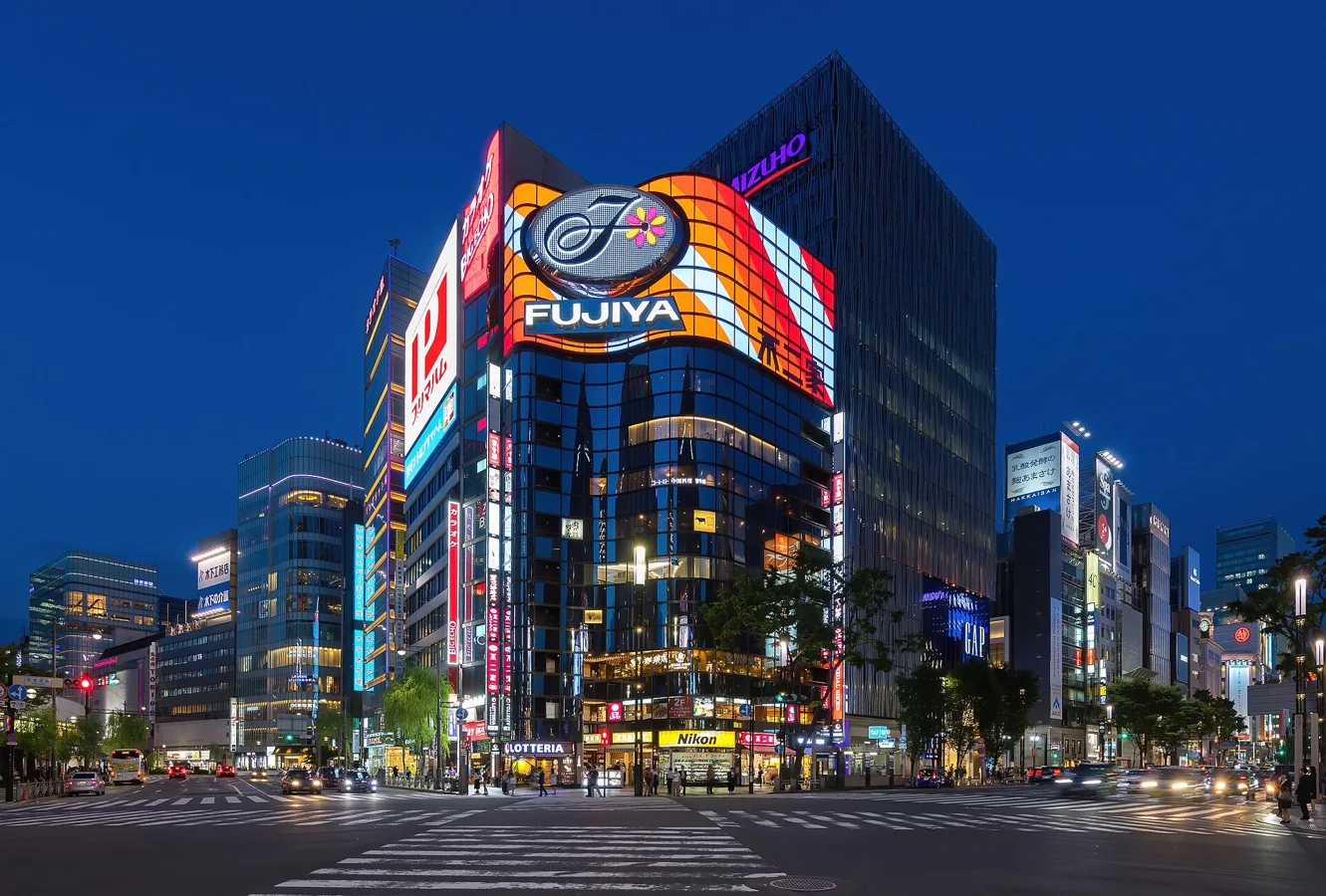 Illuminated street corner at blue hour - facade of the building Fujiya in Ginza Chuo-ku Tokyo Japan